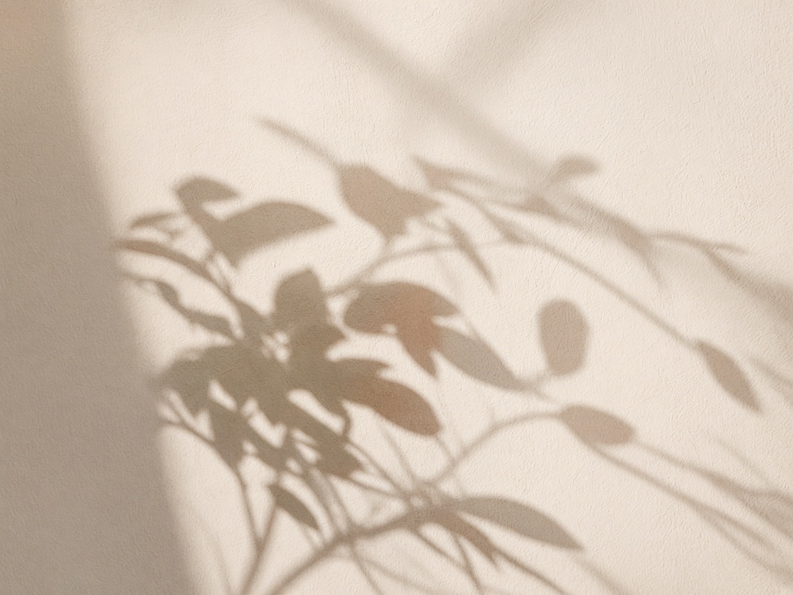 Abstract botanical shadow on cream plaster
